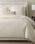 alesandra percale knife edge duvet cover in the color ivory features a button closure and ribbon ties inside each corner