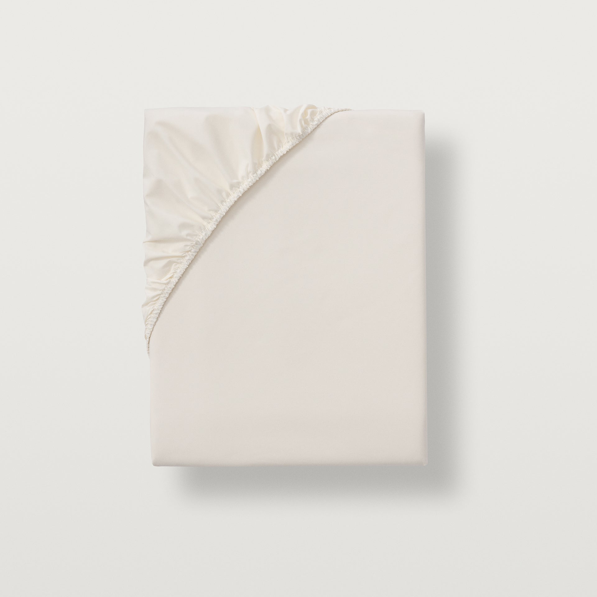 alesandra percale fitted sheet with all around sewen elastic skirt. Fits mattresses up to 17" deep.  #color_ivory