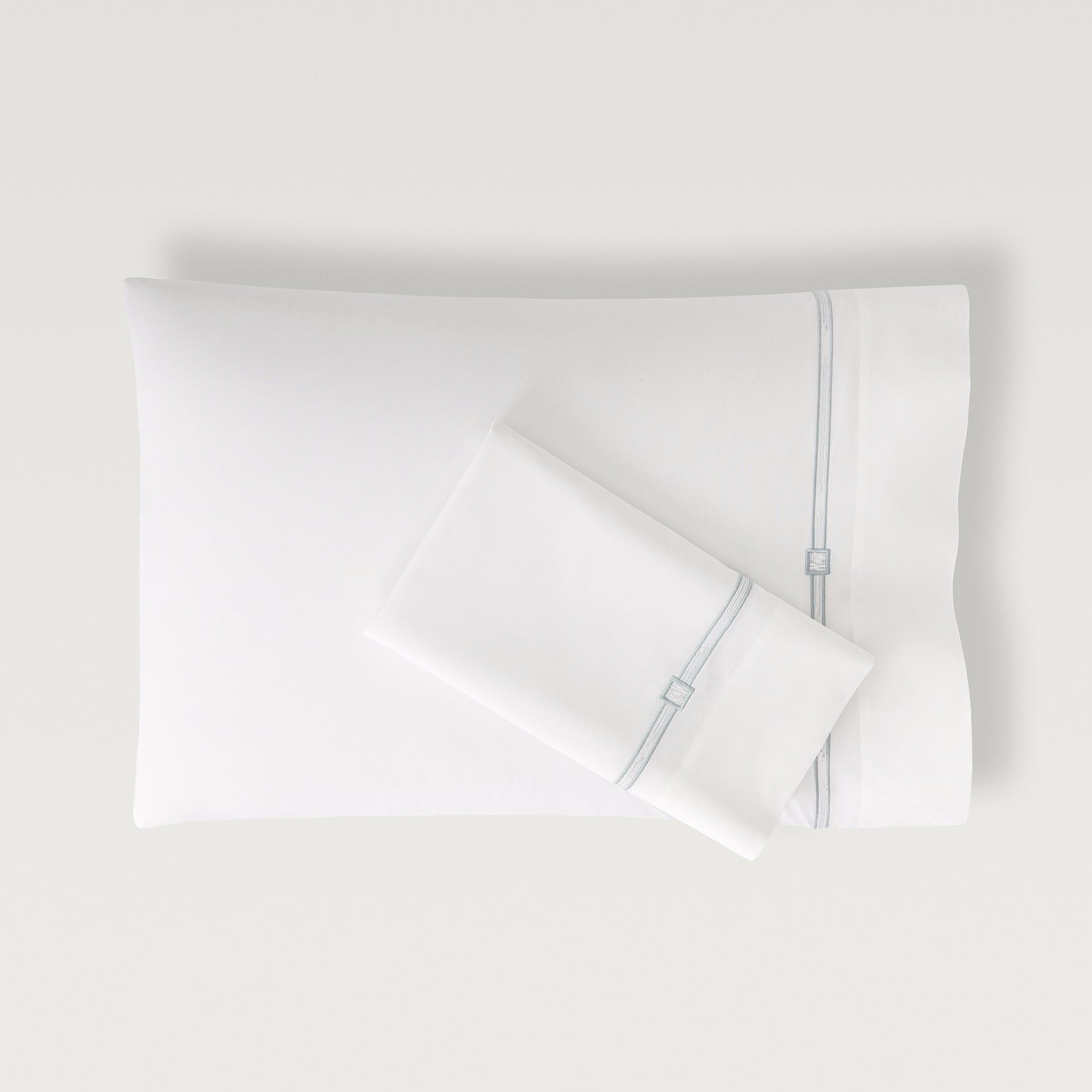 Lisetta Pillowcase with close up detail of embroidery pattern in the color cloud