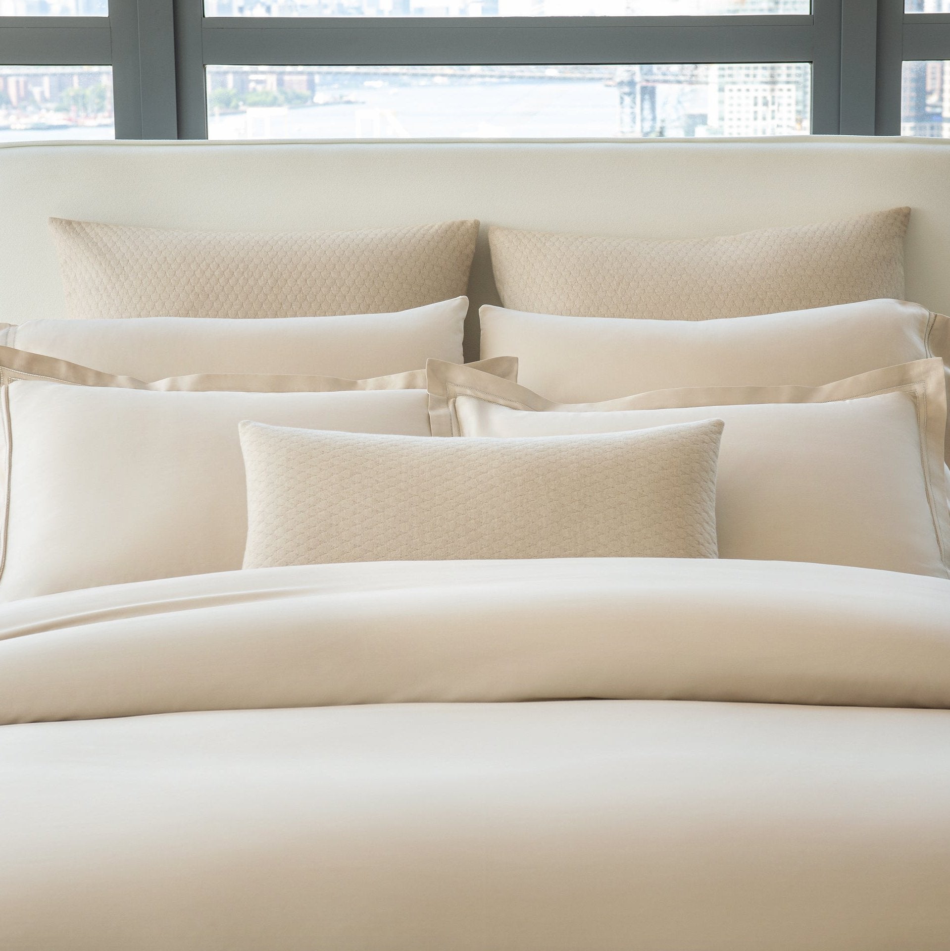 Ravello Euro Shams and Lumbar Dec pillow in the color linen paired with Lucea Sea Island Fawn.