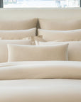 Paired Lucea Fawn pillowcases and shams with Ravello shams in the color linen