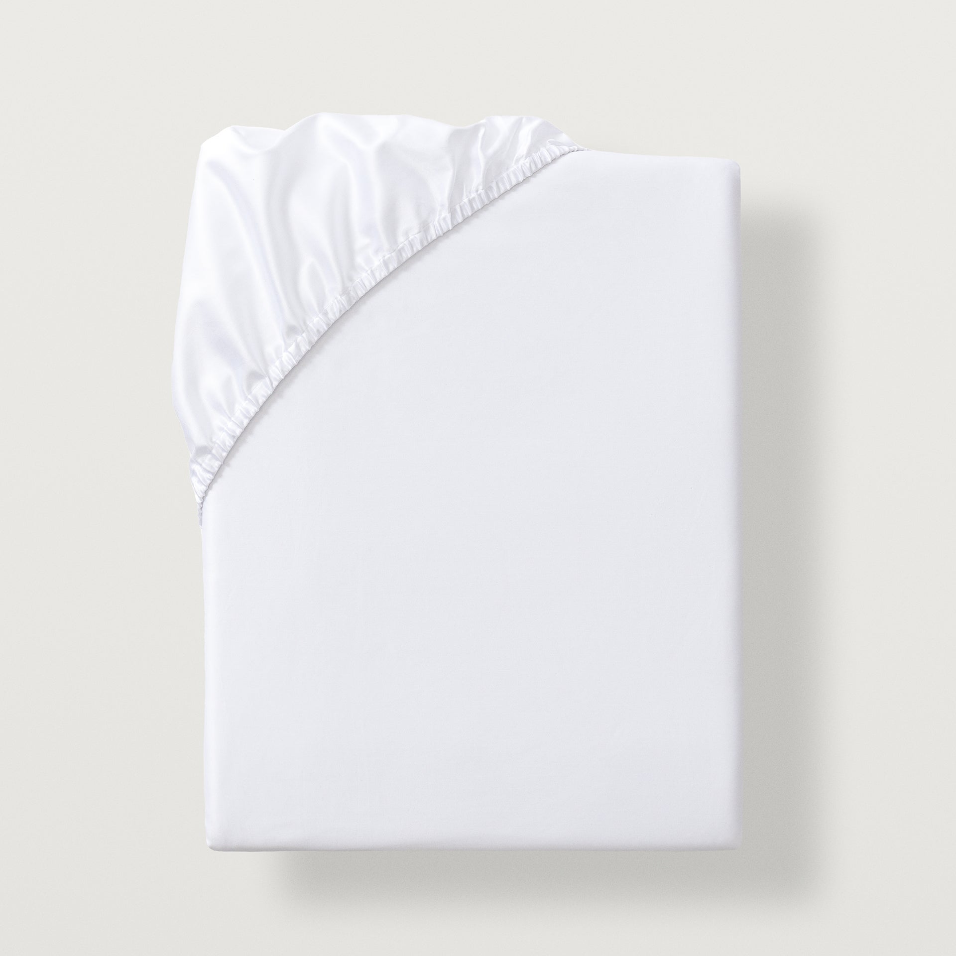 Lucea sea island cotton fitted sheet with all around elastic skirt. Fits mattresses up to 17" deep #color_white