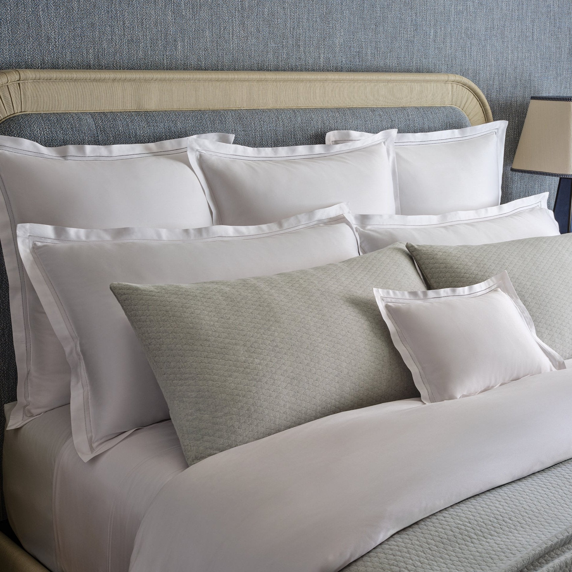 close up detail of Lucea's double hemstitch finish shams in white along side Ravello cove shams.