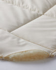 detail of the bio wool mattress pad of 100% merino pure wool inside and 100% cotton pad fabric outside