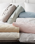 scandia home down blankets in every color selection folded on a bed