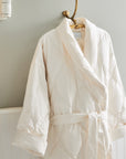 close up shot of scandia home down robe in the color ivory