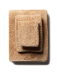 scandia home's indulgence wash, hand, and bath towel folded in the color bronze