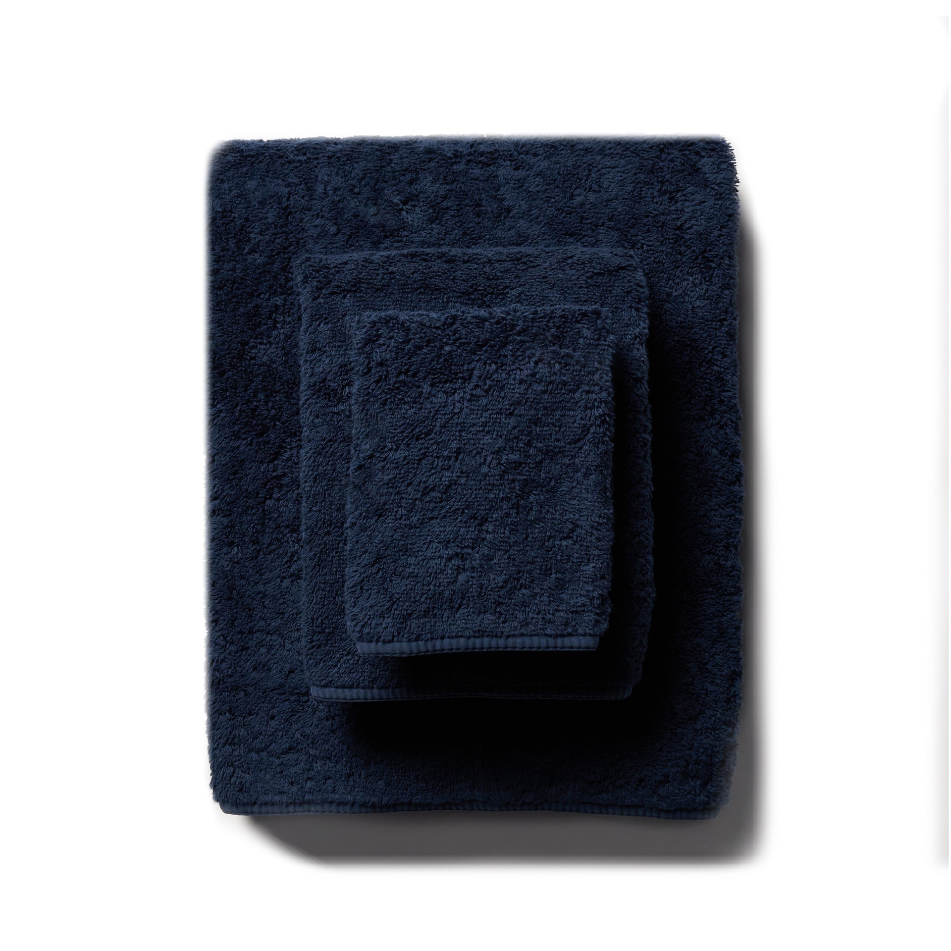 scandia home&#39;s indulgence wash, hand, and bath towel folded in the color midnight  