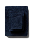 scandia home's indulgence wash, hand, and bath towel folded in the color midnight  