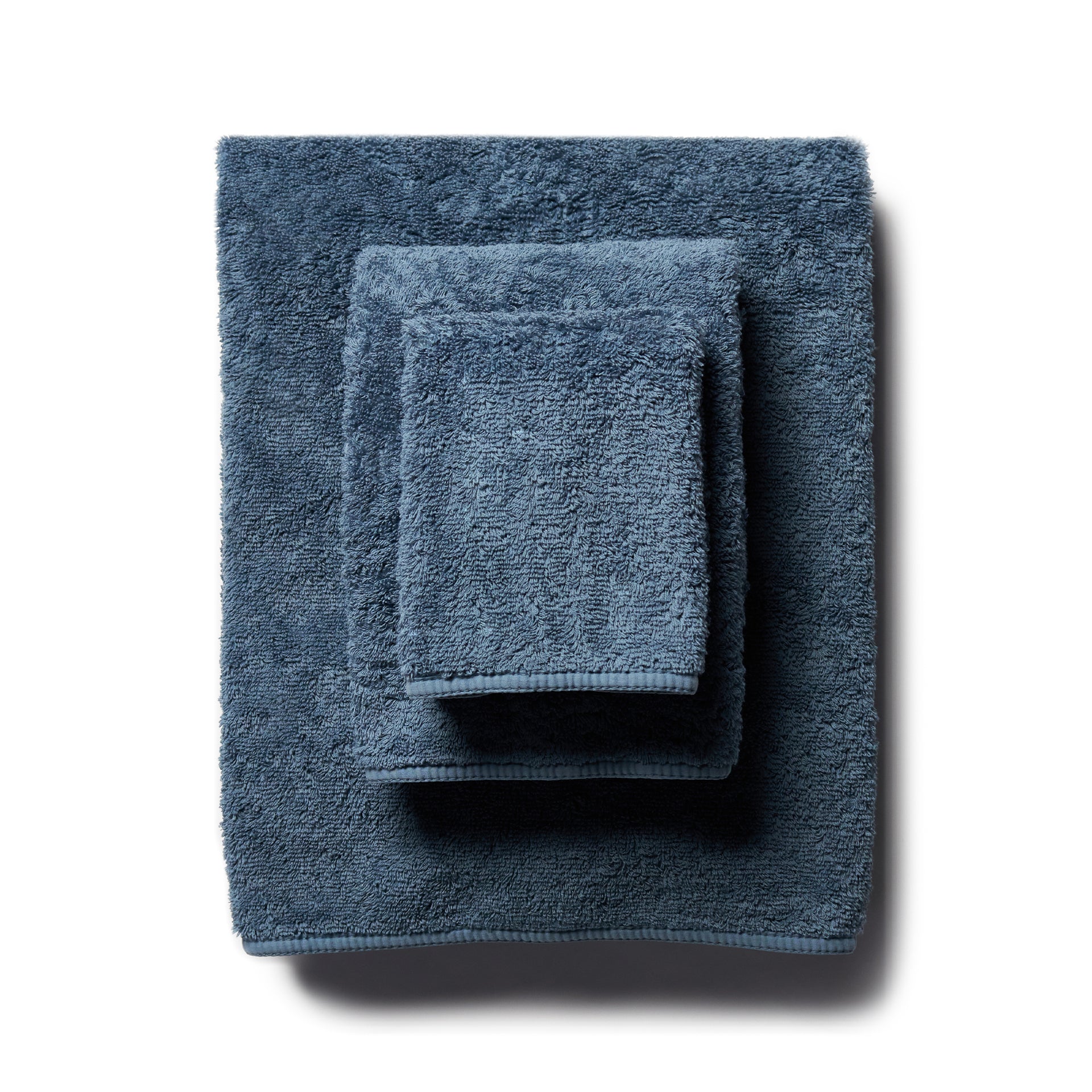 scandia home&#39;s indulgence wash, hand, and bath towel folded in the color petrol  