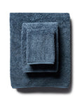 scandia home's indulgence wash, hand, and bath towel folded in the color petrol  