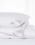 scandia home lucerne comforter and pillow filled with hungarian down folded together on bed
