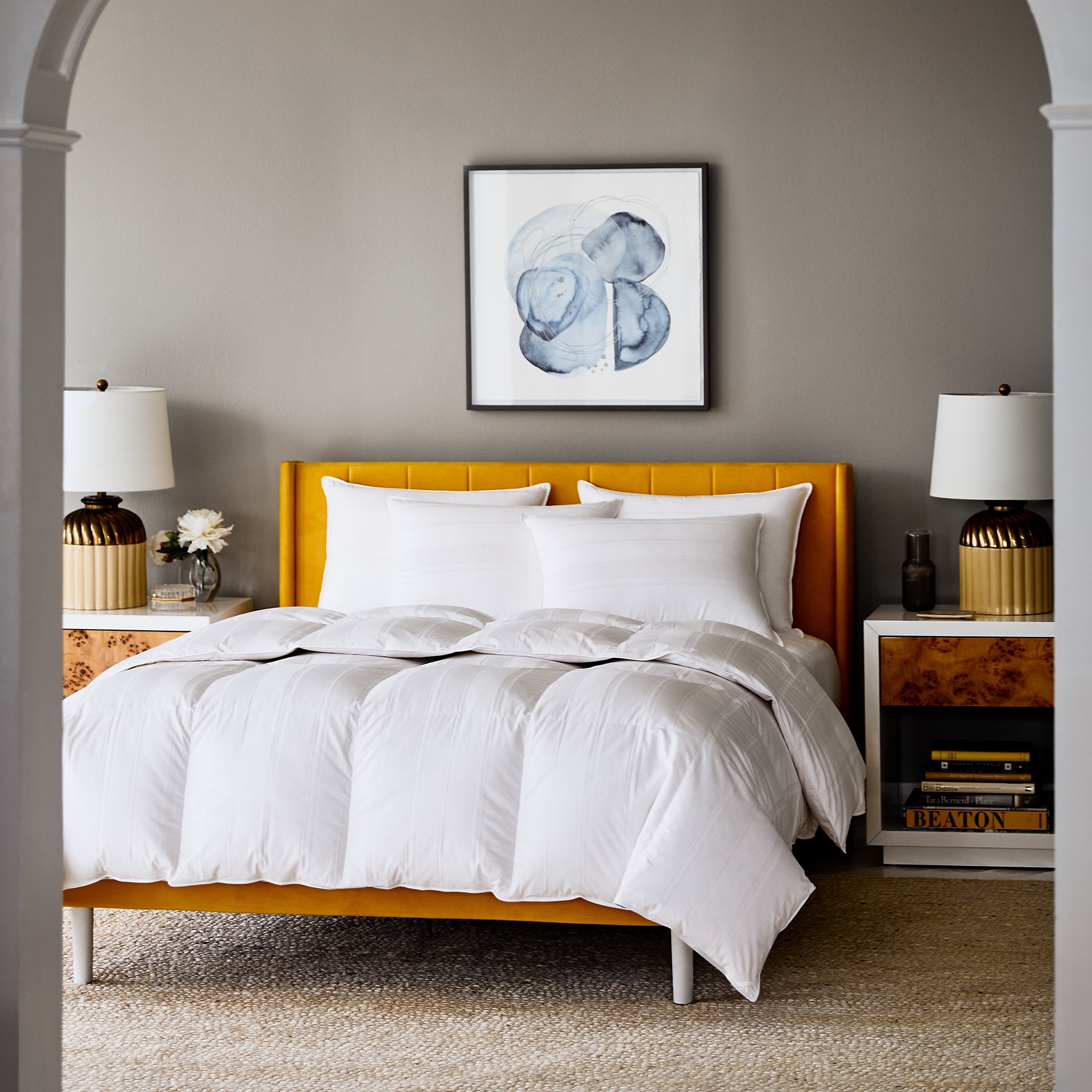 scandia home lucerne down bedding collection shown on a mustard yellow bed