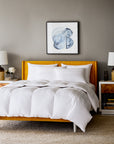 scandia home lucerne down bedding collection shown on a mustard yellow bed