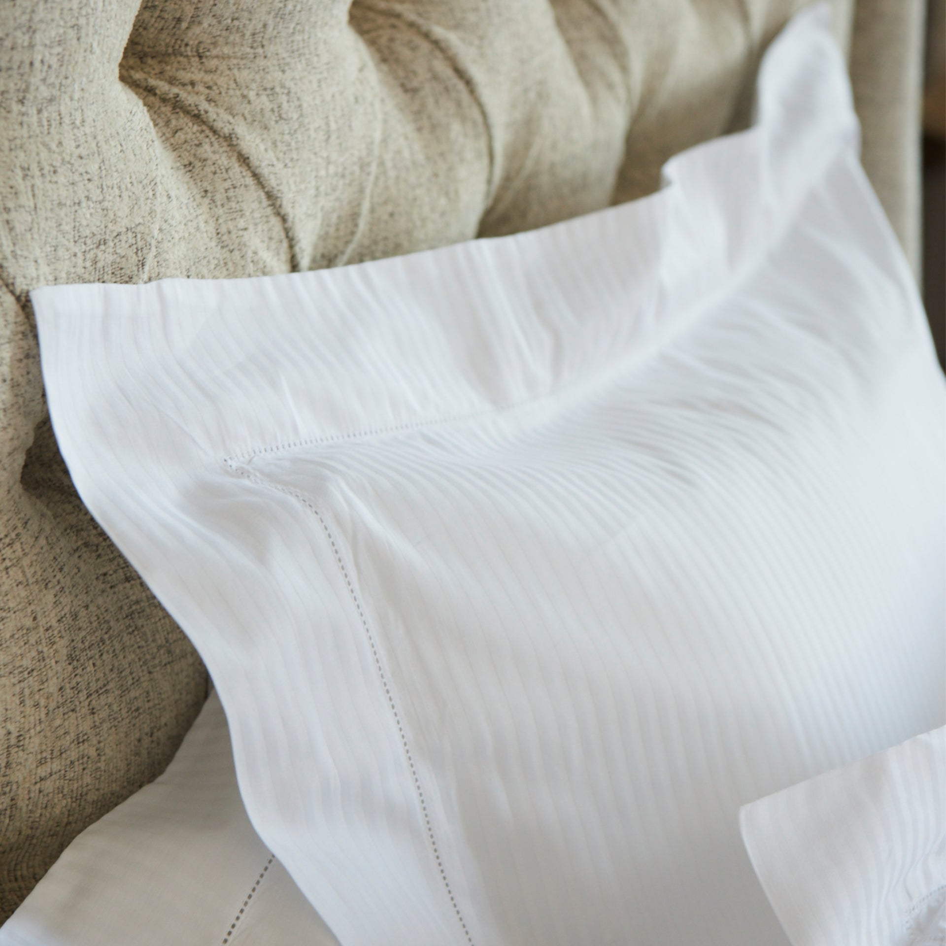detail close up of the savoia stripe euro pillow sham with the 3 inch hemstitch flange