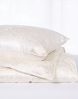 scandia home st.petersburg pillow on top of a folded st. petersburg comforter 