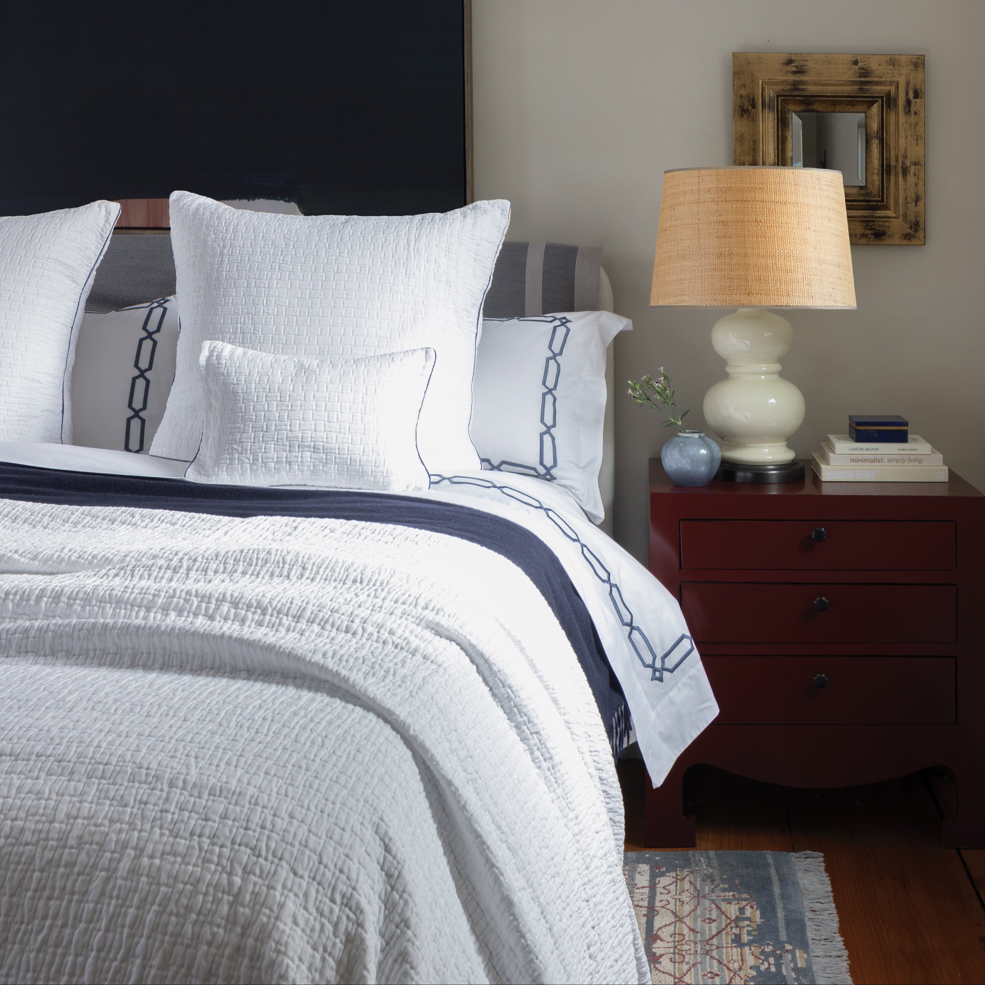 Portia coverlet in white paired with our arezzo marine embroidered sheeting