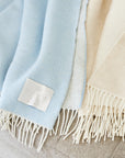 a luxuriously soft and silky reversible cashmere throw. Offered in five classic colors.