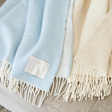 a luxuriously soft and silky reversible cashmere throw. Offered in five classic colors.