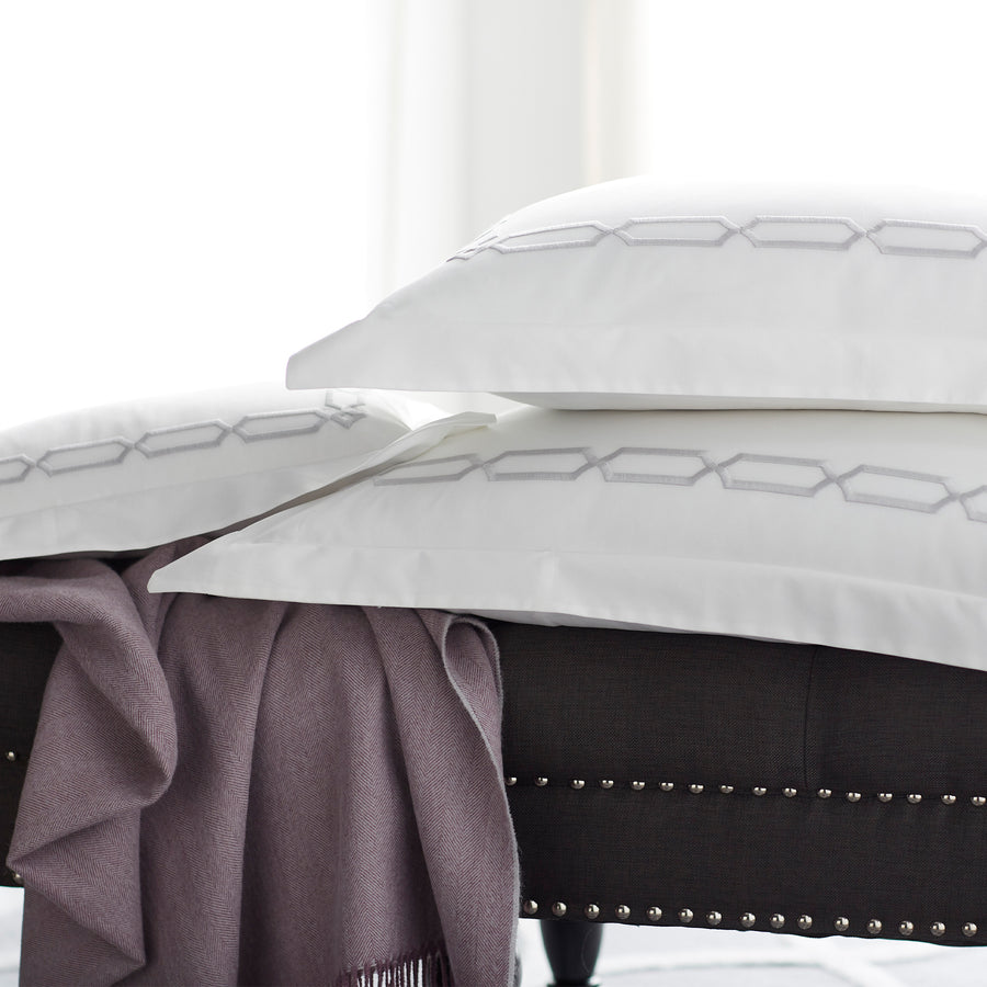 arezzo embroidered standard shams in the color shadow & white on bench with cashmere blanket, #color_shadow & white