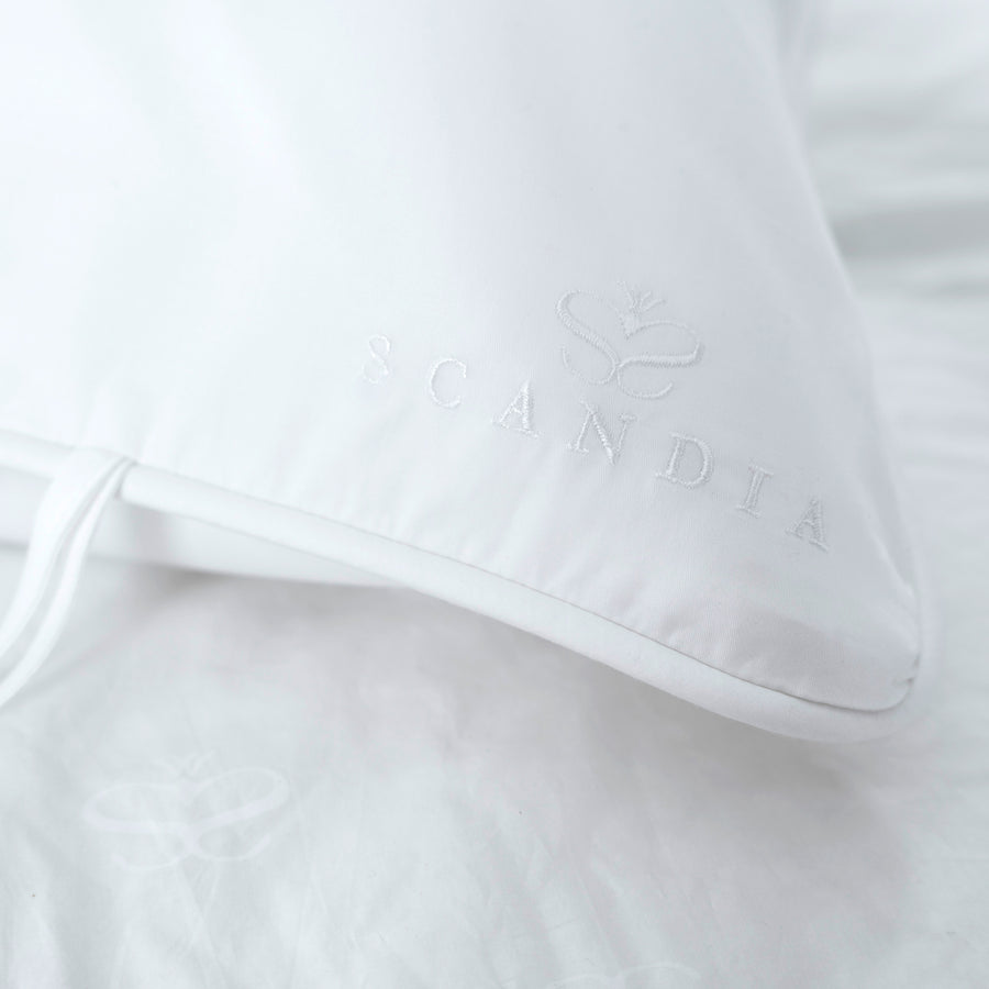 detail of embroidered scandia home crest on the pillowcase