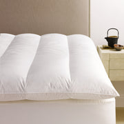  our heirloom-quality white down featherbed cradles the body in the soft support of 600-fill-power European white down