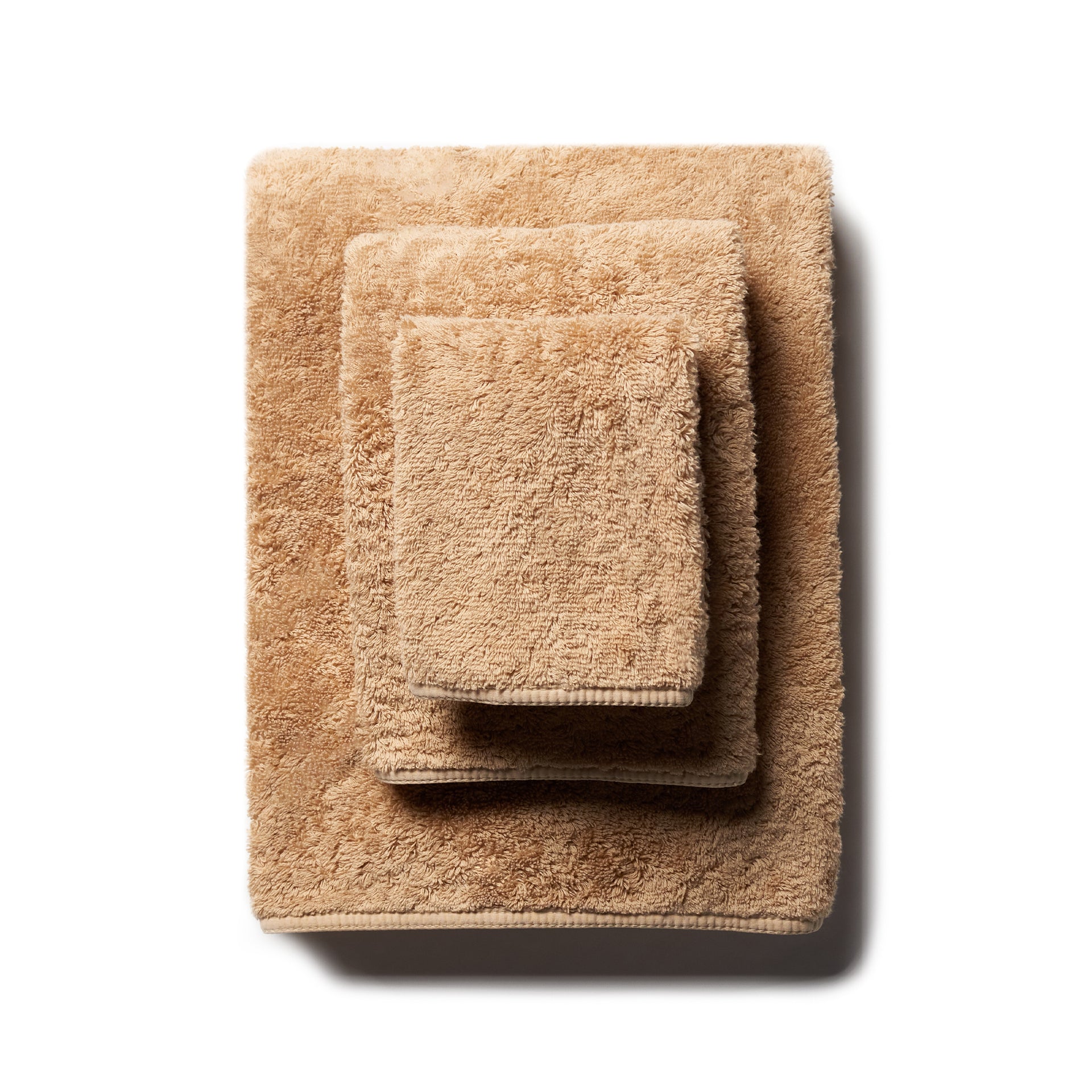 scandia home's indulgence wash, hand, and bath towel folded in the color bronze  #color_bronze