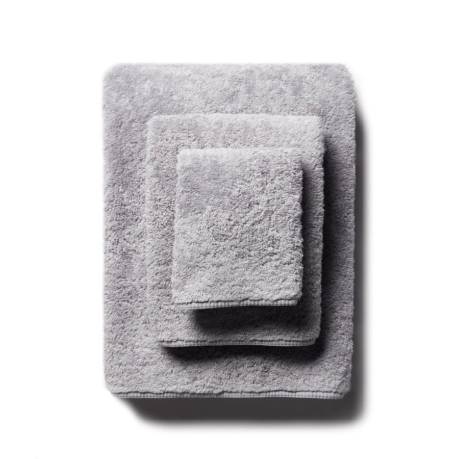 scandia home's indulgence wash, hand, and bath towel folded in the color silver  #color_silver