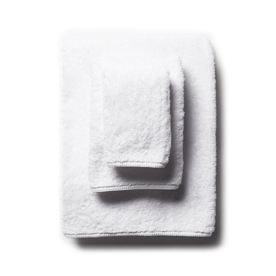 scandia home's indulgence wash, hand, and bath towel folded in the color white  #color_white