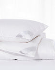 scandia home lucerne comforter and pillow filled with hungarian down folded together on bed 