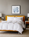 scandia home lucerne down bedding collection shown on a mustard yellow bed 