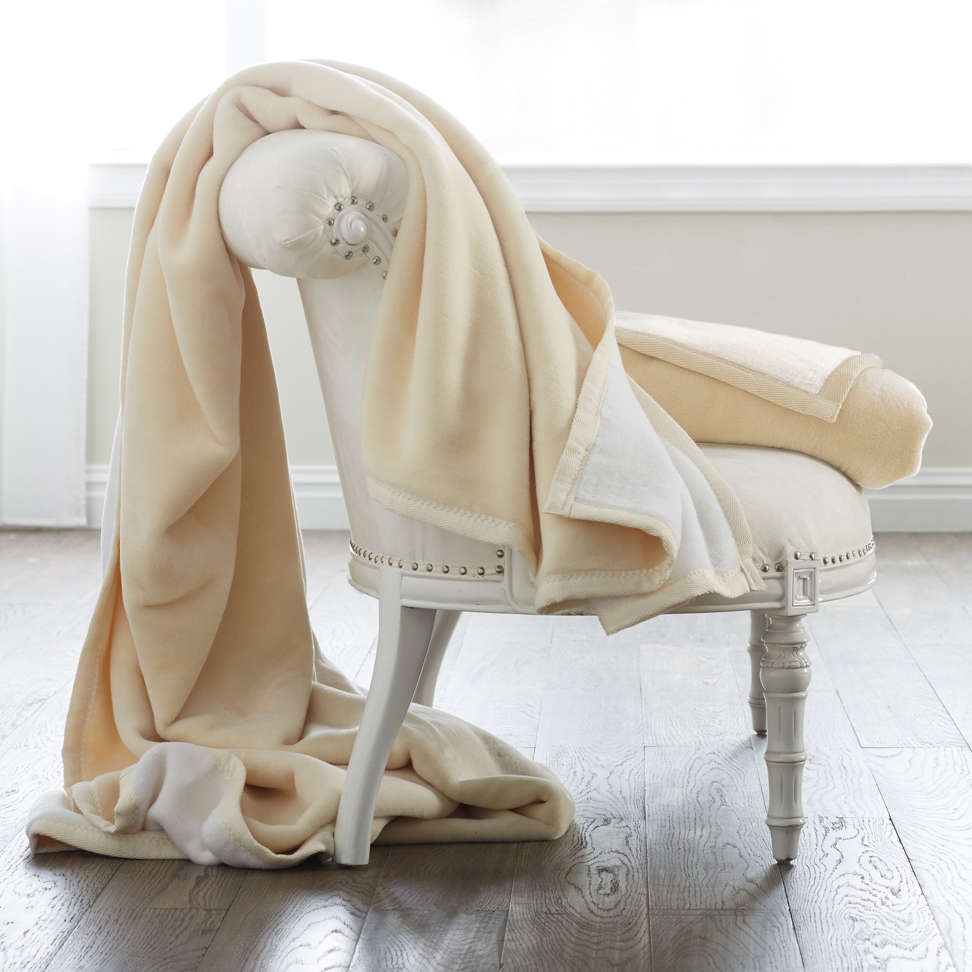 a blanket made from two layers of soft, thick cotton in a velvety pile. Reverses from white to cream for added versatility.