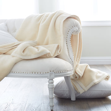 whether drapped across a sofa or folded at the foot of a bed, this plush cotton blanket adds the perfect touch of warmth, #color_white & cream