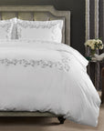 san remo duvet cover with a romantic scroll embroidered detail shown in color shadow & white