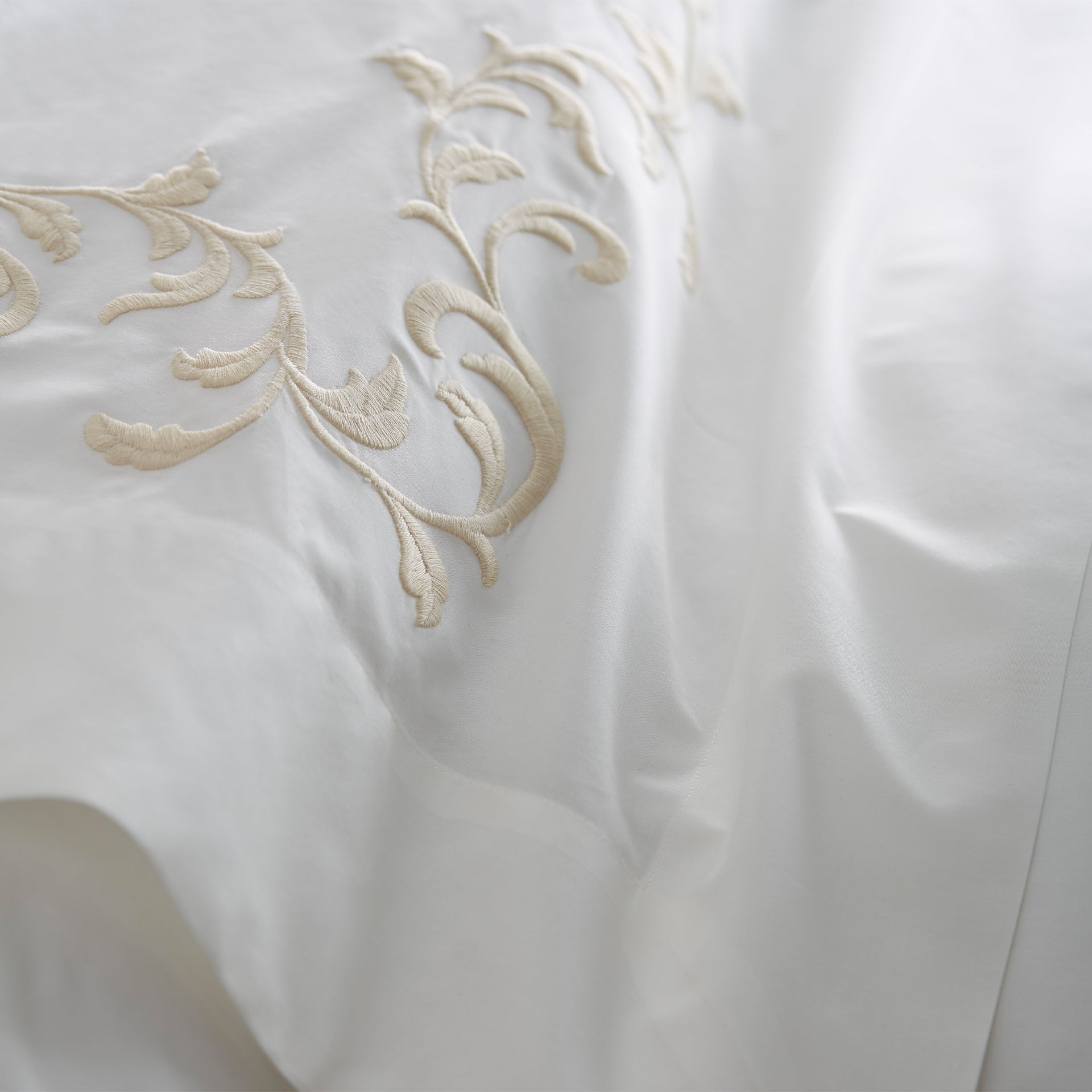 close up detail of san remo embroidered flat sheet in the color cornsilk and ivory, #color_cornsilk & ivory