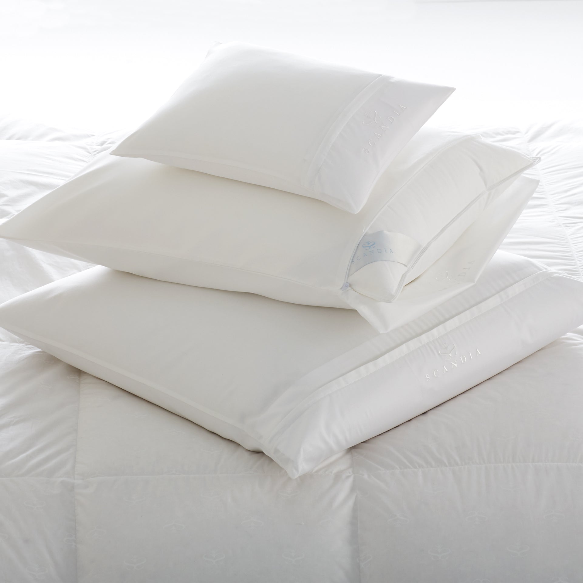 Stacked Scandia pillows covered with our 350 sateen pillow protector covers