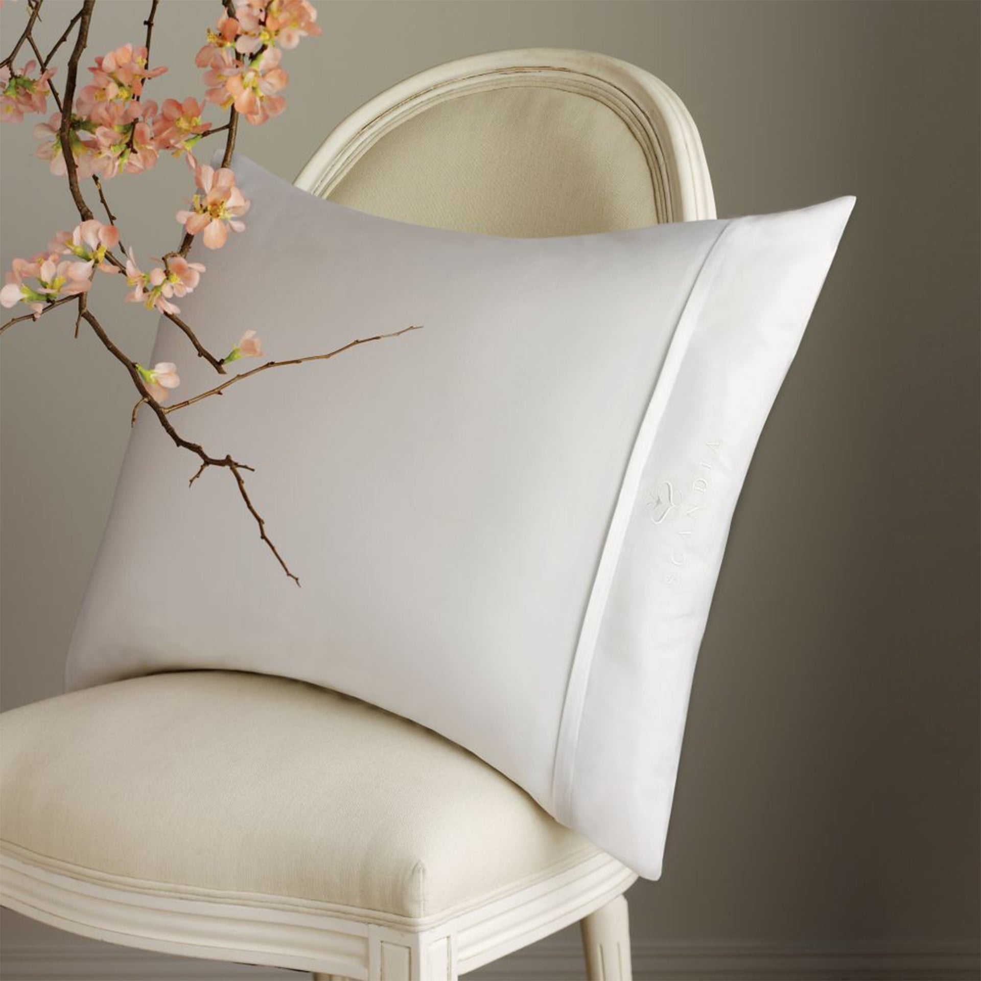 Pillow covered with our Sateen pillow protector, zipped closed showing Scandia Crest embroidery