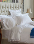 savoia stripe pillowcases with pillow shams on bed. standard and king sizes sold in pairs. travel sold individually