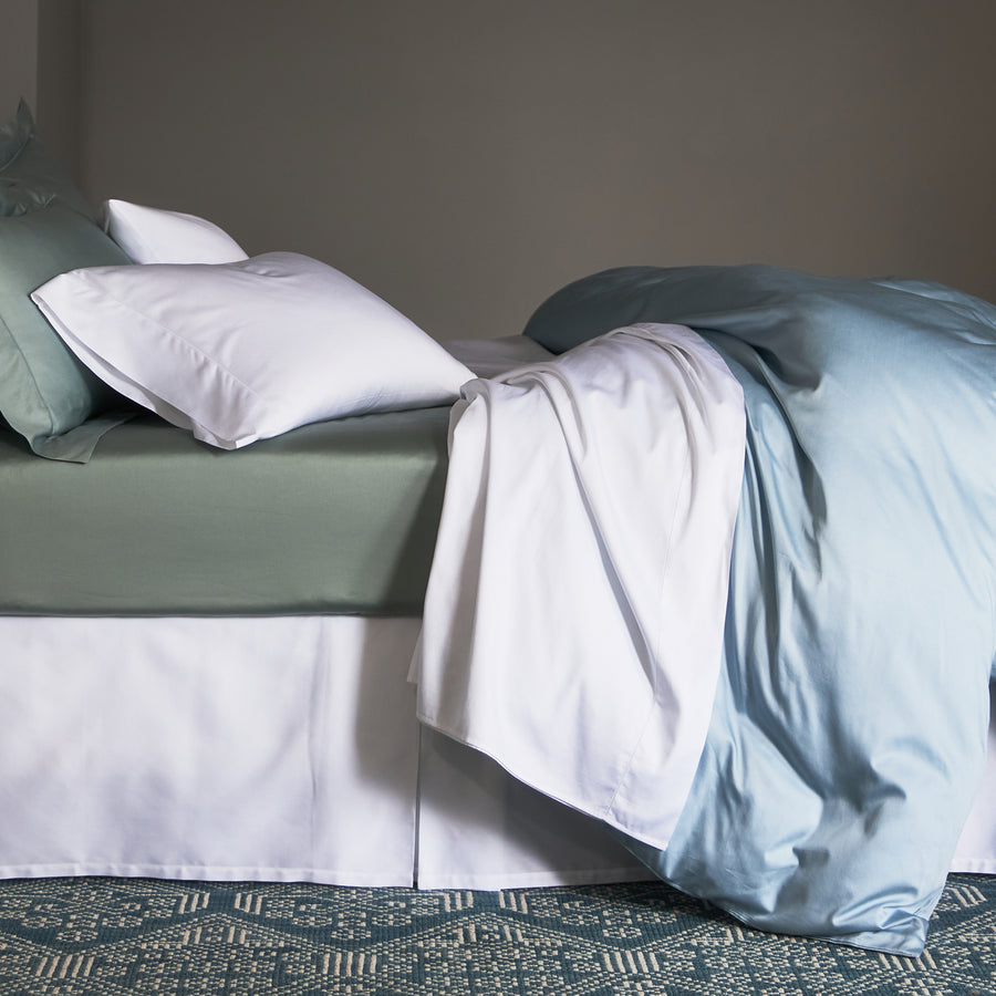 300 thread count egyptian cotton stresa sateen fitted sheet in the color heath paired with a white flat sheet