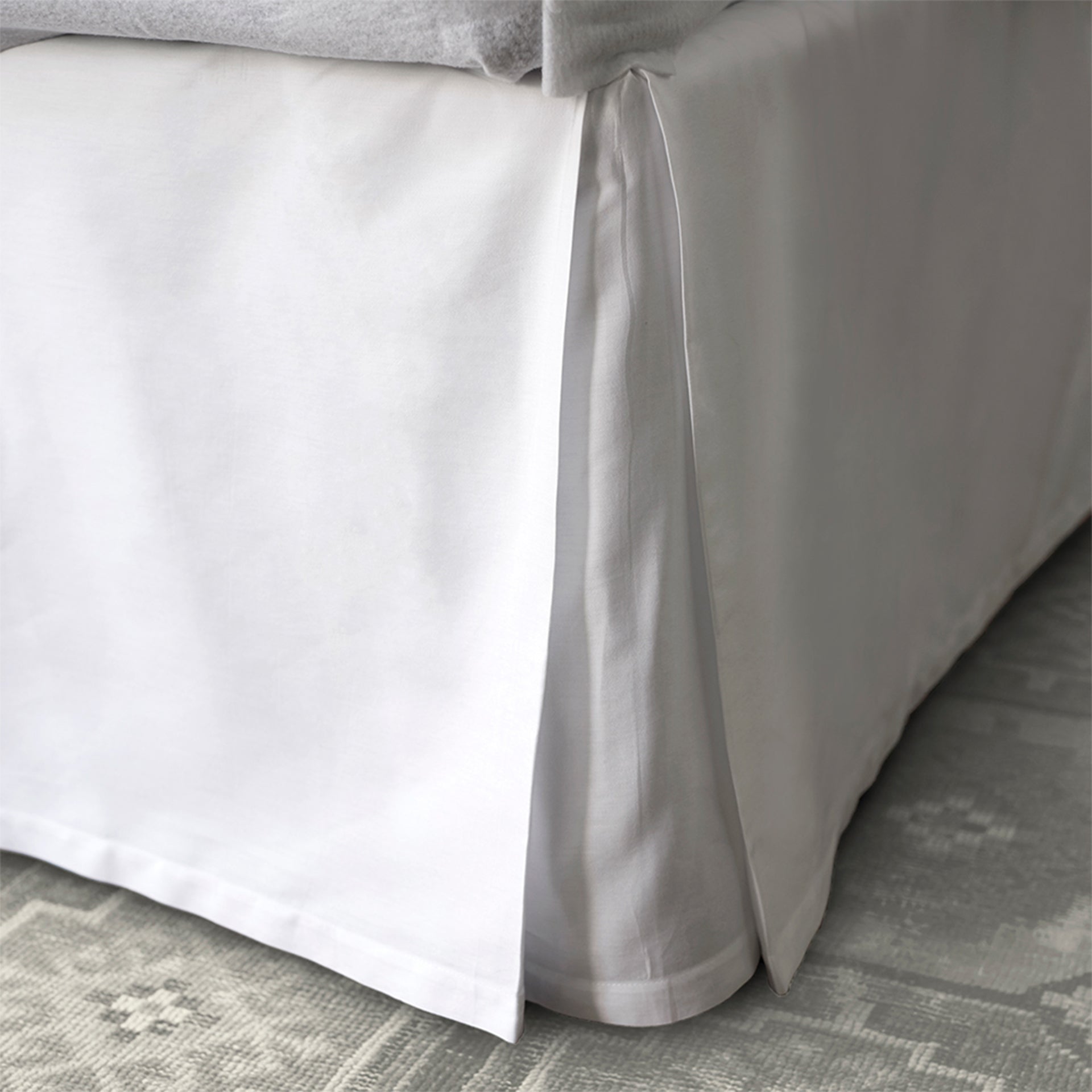 stresa sateen tailored bedskirt in the color white with a three-panel, center-pleated construction