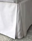 stresa sateen tailored bedskirt in the color white with a three-panel, center-pleated construction